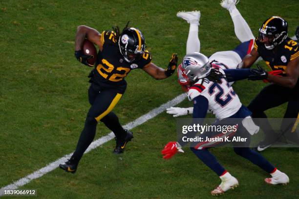 Najee Harris of the Pittsburgh Steelers stiff arms Kyle Dugger of the New England Patriots in the second half at Acrisure Stadium on December 07,...