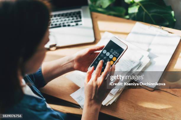 woman accountant use calculator and computer with holding pen on - calculator stock pictures, royalty-free photos & images