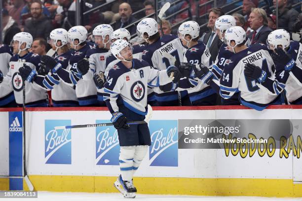 Josh Morrissey of the Winnipeg Jets celebrates with his teammates after scoring against the Colorado Avalanche in the second period at Ball Arena on...