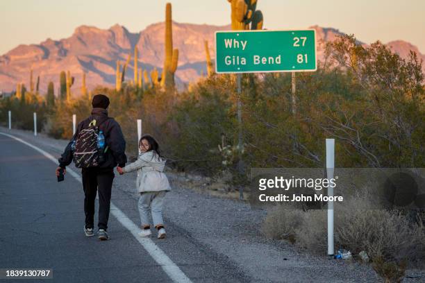 Immigrants from Ecuador walk into the United States after crossing the U.S.-Mexico border on December 07, 2023 in Lukeville, Arizona. A surge of...