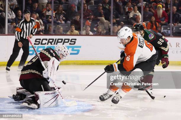 Travis Sanheim of the Philadelphia Flyers attempts a shot on goaltender Connor Ingram of the Arizona Coyotes during the third period of the NHL game...