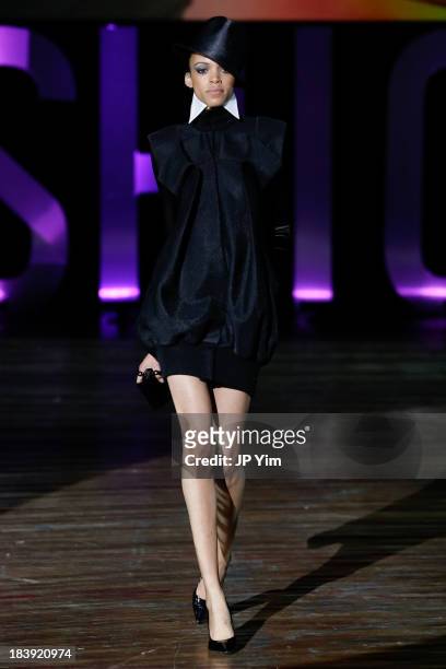 Model walks the runway wearing Sukeina during the 3rd Annual United Colors Of Fashion Gala at Lexington Avenue Armory on October 9, 2013 in New York...