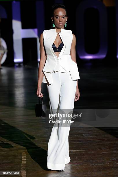 Model walks the runway wearing Sukeina during the 3rd Annual United Colors Of Fashion Gala at Lexington Avenue Armory on October 9, 2013 in New York...