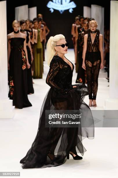 Actress Ajda Pekkan walks the runway at the Raisa-Vanessa Sason show during Mercedes-Benz Fashion Week Istanbul s/s 2014 Presented By American...