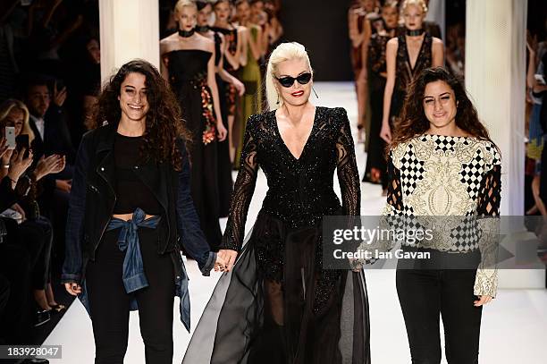 Fashion designers Raisa Sason , Vanessa Sason and actress Ajda Pekkan walk the runway at the Raisa-Vanessa Sason show during Mercedes-Benz Fashion...