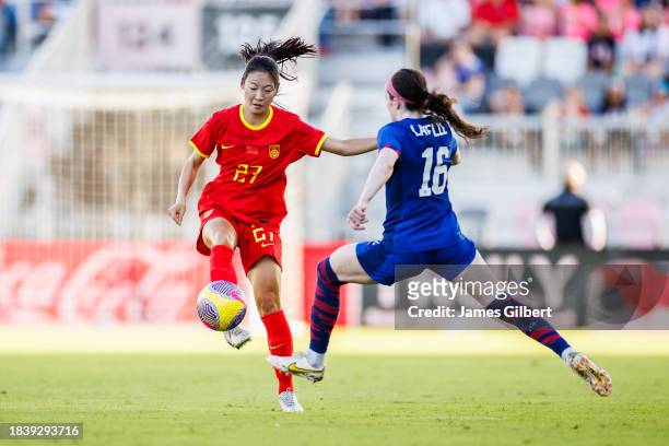 Huo Yuexin of China PR dribbles the ball against Rose Lavelle of the United States during the second half of a match at DRV PNK Stadium on December...