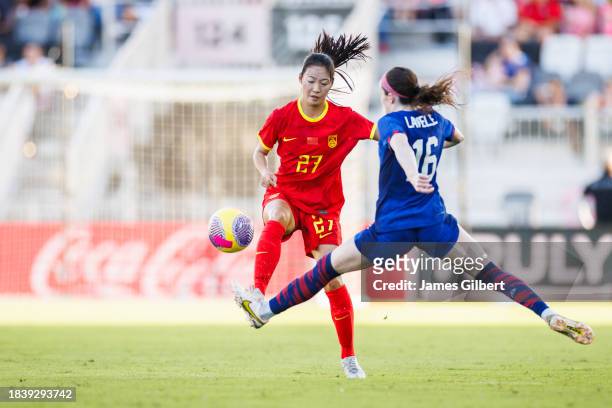 Huo Yuexin of China PR dribbles the ball against Rose Lavelle of the United States during the second half of a match at DRV PNK Stadium on December...