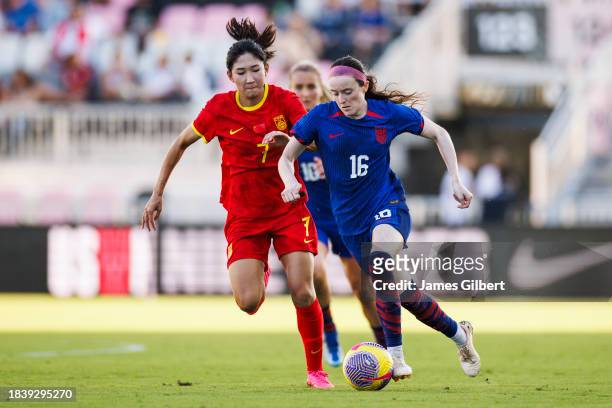 Rose Lavelle of the United States dribbles the ball against Wang Yanwen of China PR during the second half of a match at DRV PNK Stadium on December...