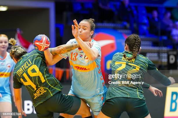 Yvette Broch of the Netherlands attacking and defends by Patricia Matieli Machado of Brazil, Kelly Mattieli Machado of Brazil during the 26th IHF...