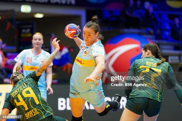 Yvette Broch of the Netherlands attacking and defends by Patricia Matieli Machado of Brazil, Kelly Mattieli Machado of Brazil during the 26th IHF...