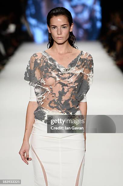 Model walks the runway at the Tuba Ergin show during Mercedes-Benz Fashion Week Istanbul s/s 2014 Presented By American Express on October 10, 2013...