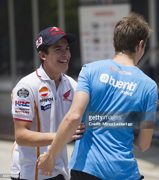 Marc Marquez of Spain and Repsol Honda Team greets Esteve Rabat of Spain and Pons 40 HP Tuenti in paddock during the MotoGP Of Malaysia - Preview at...