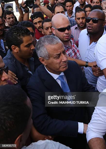 Libyan Prime Minister Ali Zeidan arrives at the government headquarters in Tripoli on October 10, 2013 shortly after he was freed from the captivity...