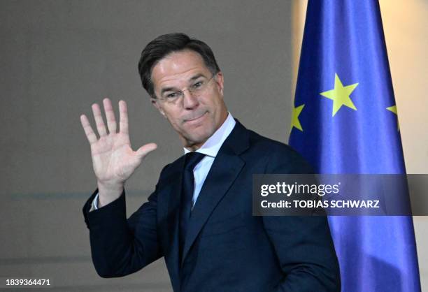 Dutch Prime Minister Mark Rutte waves as he leaves a joint press conference with German Chancellor following talks at the Chancellery in Berlin on...