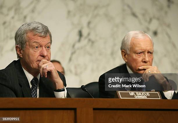 Sen. Max Baucus and Sen. Orin Hatch listen to Treasury Secretary Jack Lew speak during a Senate Finance Committee hearing on Capitol Hill, October...