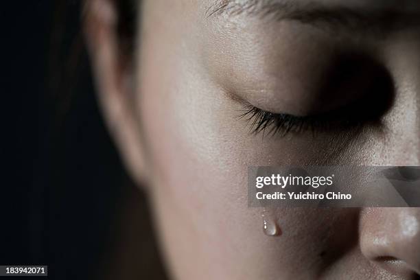 crying young woman - teardrop stock pictures, royalty-free photos & images