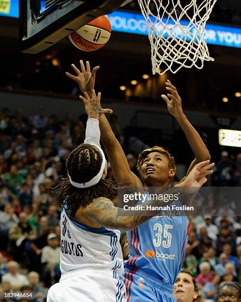 Angel McCoughtry of the Atlanta Dream makes a shot against Seimone Augustus of the Minnesota Lynx during Game One of the 2013 WNBA Finals on October...