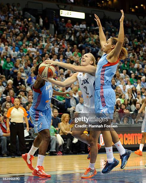Lindsey Moore of the Minnesota Lynx shoots the ball against Aneika Henry and Courtney Clements of the Atlanta Dream during Game One of the 2013 WNBA...