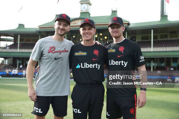 Joe Clarke, Adam Zampa and Jordan Cox of the Renegades pose after receiving their players cap ahead of the BBL match between Sydney Sixers and...