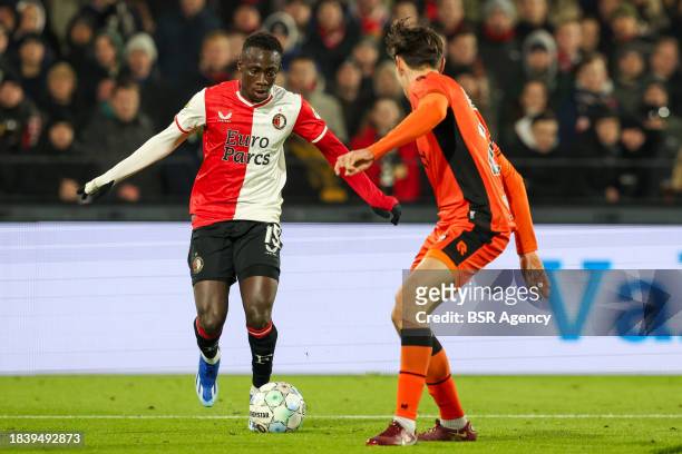 Yankuba Minteh of Feyenoord is challenged by Josh Flint of FC Volendam during the Dutch Eredivisie match between Feyenoord and FC Volendam at Stadion...