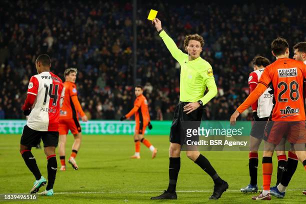Referee Martin van den Kerkhof shows the yellow card to Igor Paixao of Feyenoord during the Dutch Eredivisie match between Feyenoord and FC Volendam...