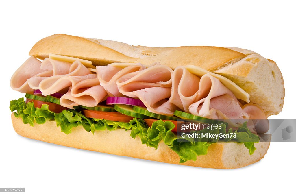 A sub sandwich overflowing with ham