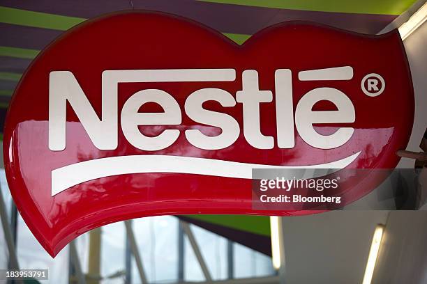 The Nestle SA logo is displayed at the company's chocolate production plant plant in Toluca, Mexico, on Wednesday, Oct. 2013. Nestle SA, the worlds...