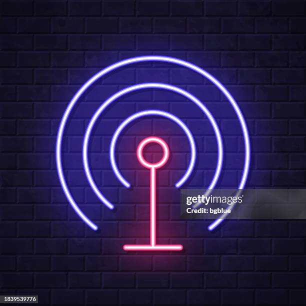 antenna. glowing neon icon on brick wall background - cell tower stock illustrations