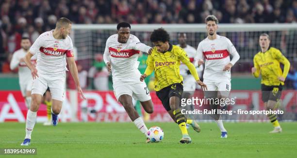 Dan-Axel Zagadou of VfB Stuttgart and Karim Adeyemi of Borussia Dortmund compete for the ball during the DFB cup round of 16 match between VfB...