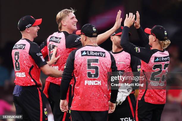 Will Sutherland of the Renegades celebrates with team mates after taking the wicket of Josh Philippe of the Sixers during the BBL match between...