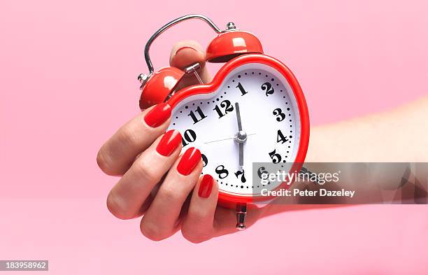 woman with biological clock ticking - frau uhr stock-fotos und bilder