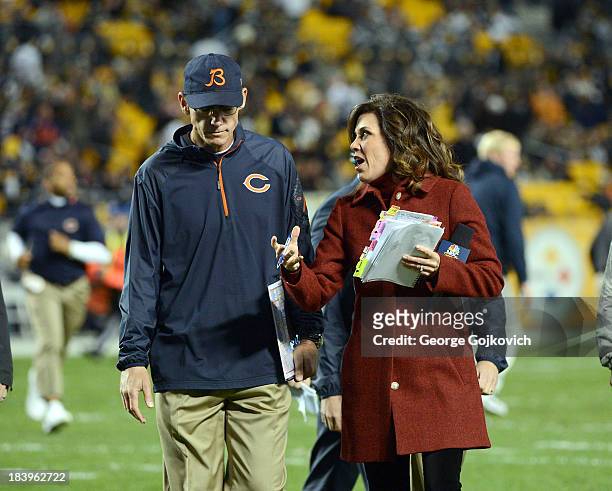 Sunday Night Football sideline reporter Michele Tafoya talks to head coach Marc Trestman of the Chicago Bears during halftime of a game against the...