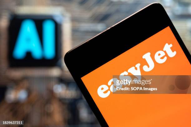 In this photo illustration, the British multinational low-cost airline, EasyJet, logo seen displayed on a smartphone with an Artificial intelligence...