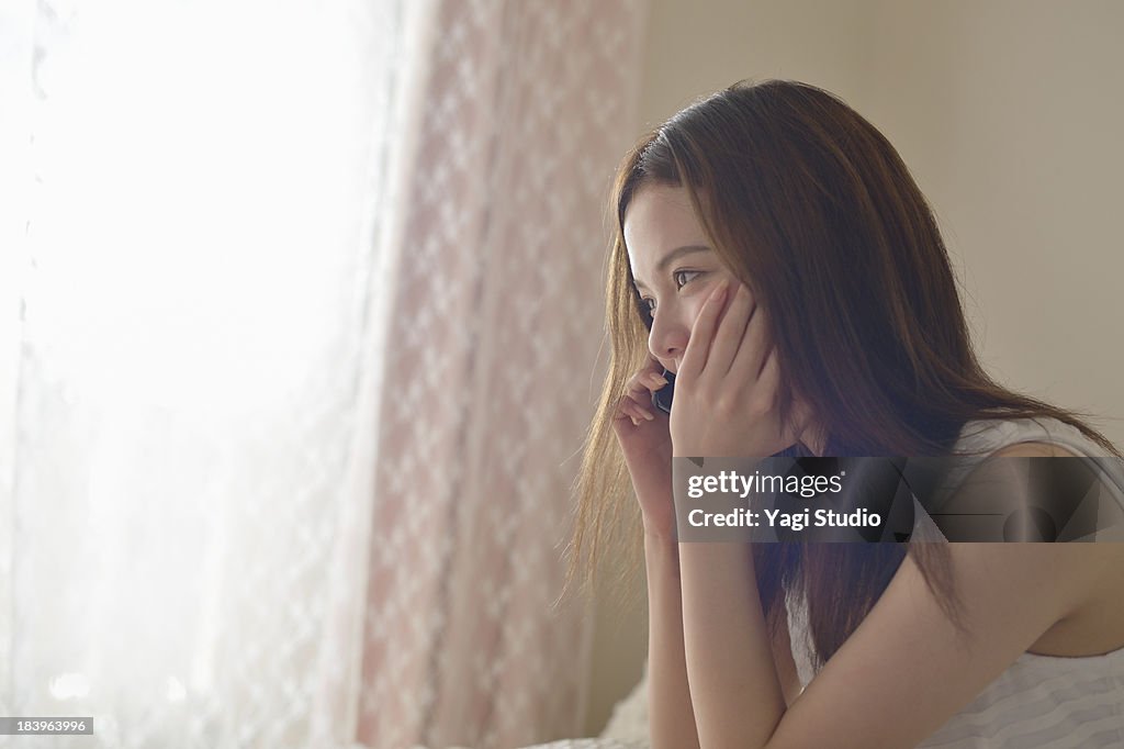 Women using Smartphone on the sofa.