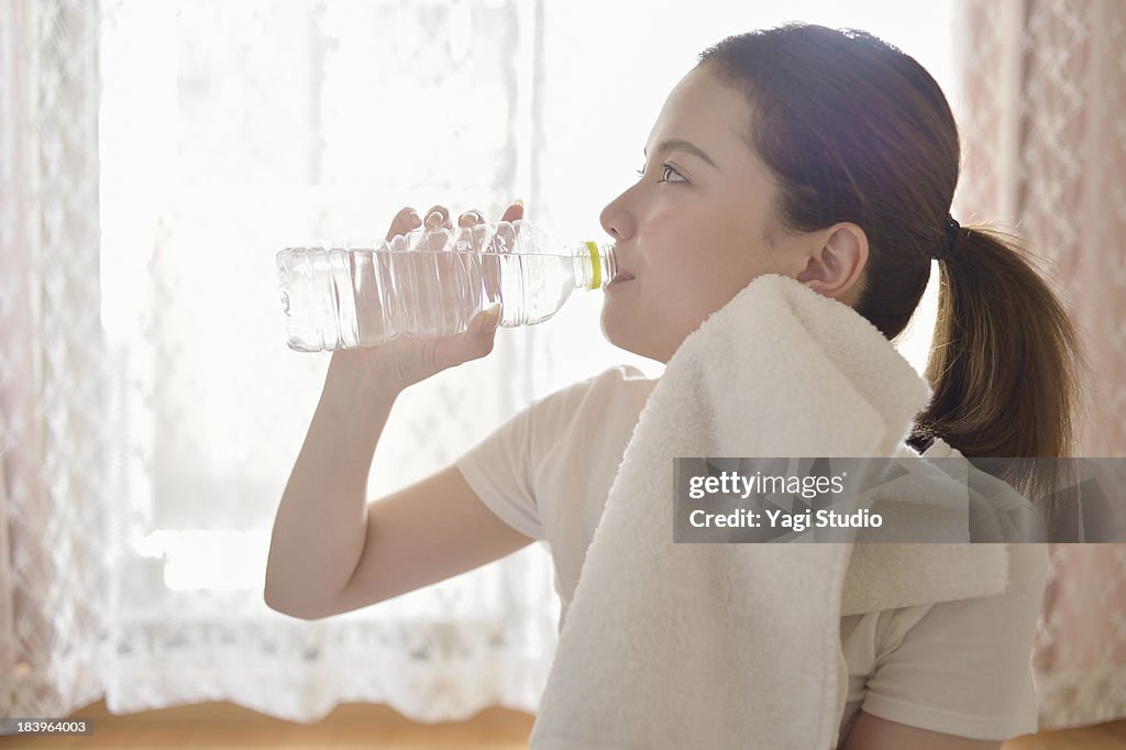 Woman drinking water in the room