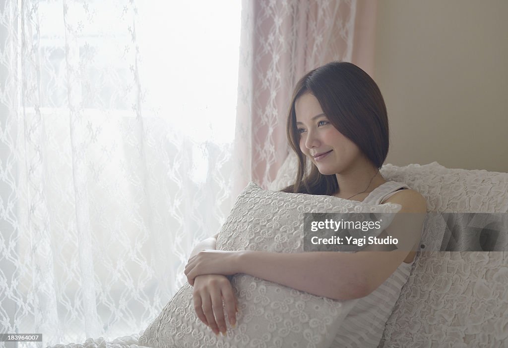 Woman is relaxing in the room.