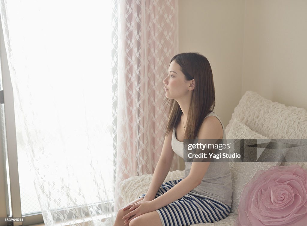 Woman is relaxing in the room.