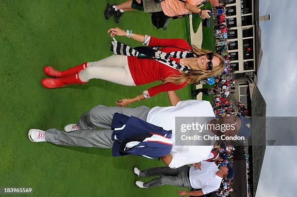 Team Captain Fred Couples walks off the 18th green with girlfriend Nadine Moze after the U.S. Team wins The Presidents Cup at Muirfield Village Golf...