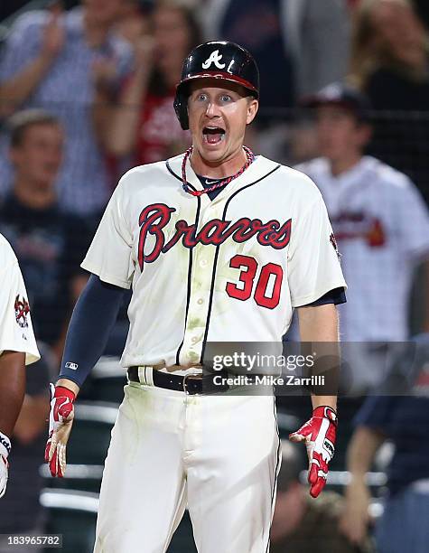 Second baseman Eliot Johnson of the Atlanta Braves reacts to a ninth inning home run during the game against the Philadelphia Phillies at Turner...