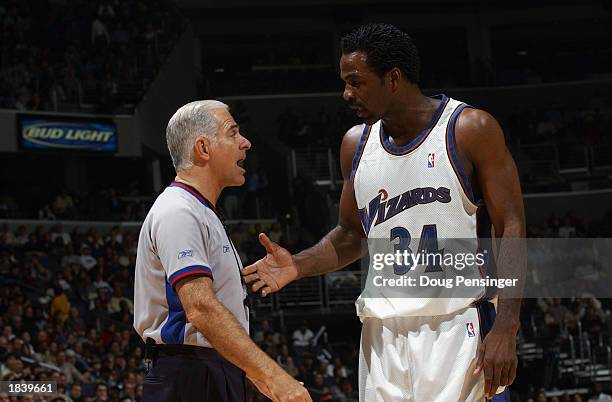 Charles Oakley of the Washington Wizards discuses the play with referee Bennett Salvatore during the NBA game against the New Jersey Nets at MCI...