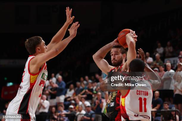 Sam Froling of the Hawks is put under pressure by Hyrum Harris and Bryce Cotton of the Wildcats during the round 10 NBL match between Illawarra Hawks...