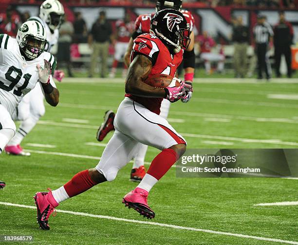 Jason Snelling of the Atlanta Falcons carries the ball against the New York Jets at the Georgia Dome on October 7, 2013 in Atlanta, Georgia.