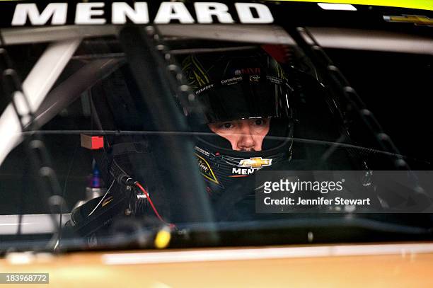 Paul Menard, driver of the Menard's / Duracell Chevrolet, sits in his car in the garage area during practice for the NASCAR Sprint Cup Series Bank of...