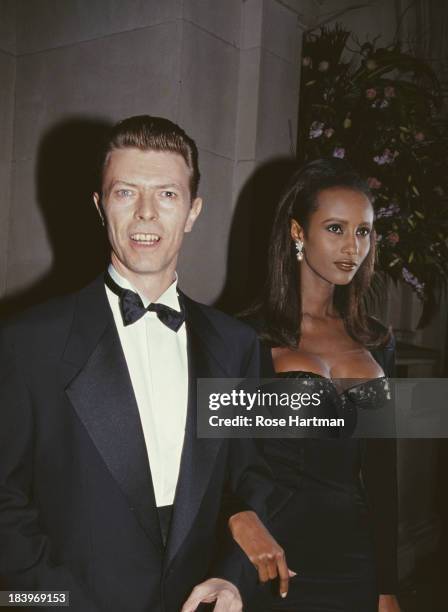 English musician, singer-songwriter, and actor David Bowie with his wife Somali fashion model Iman, circa 1995.