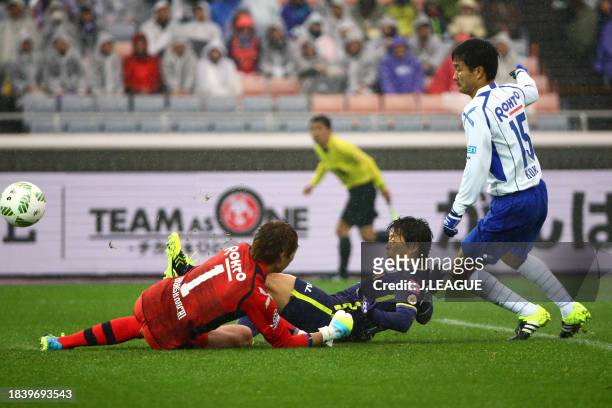 Hisato Sato of Sanfrecce Hiroshima scores the team's first goal past Masaaki Higashiguchi of Gamba Osaka during the Fuji Xerox Super Cup match...
