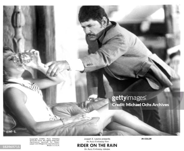 Actress Marlene Jobert and actor Charles Bronson on set of the Embassy Pictures movie "Rider on the Rain" in 1970.