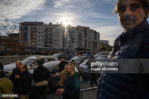 Taxi drivers gather outside the 'Caisse primaire d'assurance maladie' during a demonstration against health insurance project law of "patient...