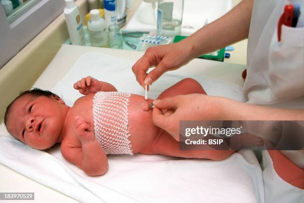 Neonatal Assistant Cleans Umbilical Cord.