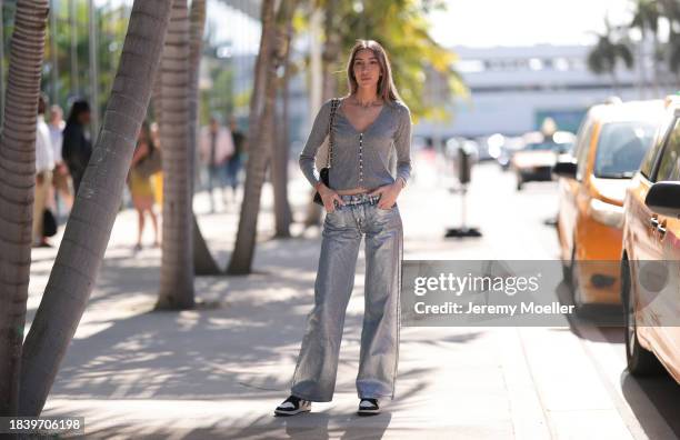 Jacqueline Sposito seen wearing gold necklaces, grey wool knit cardigan jacket, silver metallic-look denim jeans / pants, Chanel black leather...