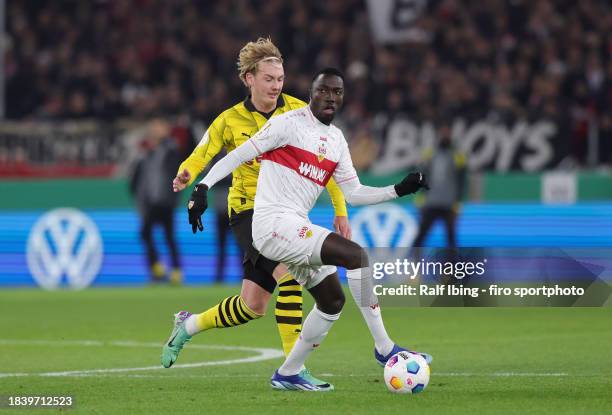 Julian Brandt of Borussia Dortmund and Silas Katompa Mvumpa of VfB Stuttgart compete for the ball during the DFB cup round of 16 match between VfB...